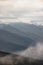 Wavey ridge lines of varying mountain ranges are contrasted by the one in front creating depth and texture in Olympic National