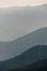 Wavey ridge lines of varying mountain ranges are contrasted by the one in front creating depth and texture in Olympic National