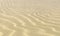 Wavey sand on beach under sunlight close-up