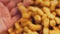 Waviness effect of The woman peels the peanuts from the retro tray. Macro slider shooting