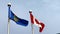 A waving Alberta Flag with the Canadian flag on a windy day