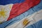 waving colorful flag of argentina and national flag of philippines
