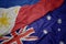 waving colorful flag of australia and national flag of philippines