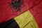 waving colorful flag of belgium and national flag of albania