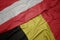 waving colorful flag of belgium and national flag of austria
