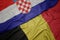 waving colorful flag of belgium and national flag of croatia