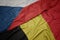 waving colorful flag of belgium and national flag of czech republic