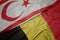 waving colorful flag of belgium and national flag of northern cyprus