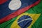 waving colorful flag of brazil and national flag of laos