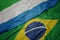 waving colorful flag of brazil and national flag of sierra leone