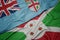 Waving colorful flag of burundi and national flag of Fiji