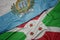 Waving colorful flag of burundi and national flag of san marino