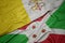 Waving colorful flag of burundi and national flag of vatican city