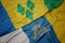 waving colorful flag of canary islands and national flag of saint vincent and the grenadines