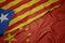 waving colorful flag of china and national flag of catalonia