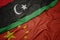 waving colorful flag of china and national flag of libya