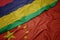 waving colorful flag of china and national flag of mauritius