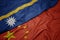 waving colorful flag of china and national flag of Nauru