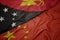 waving colorful flag of china and national flag of Papua New Guinea