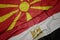 waving colorful flag of egypt and national flag of macedonia