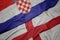 waving colorful flag of england and national flag of croatia