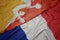 waving colorful flag of france and national flag of bhutan