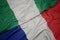 waving colorful flag of france and national flag of nigeria