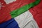 waving colorful flag of france and national flag of oman