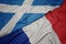waving colorful flag of france and national flag of scotland