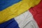 waving colorful flag of france and national flag of ukraine