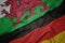 waving colorful flag of germany and national flag of wales