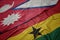 waving colorful flag of ghana and national flag of nepal