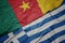 waving colorful flag of greece and national flag of cameroon