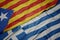 waving colorful flag of greece and national flag of catalonia
