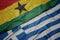 waving colorful flag of greece and national flag of ghana