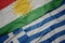 waving colorful flag of greece and national flag of kurdistan