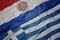 waving colorful flag of greece and national flag of paraguay