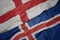 waving colorful flag of iceland and national flag of england