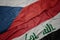 waving colorful flag of iraq and national flag of czech republic