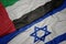 waving colorful flag of israel and national flag of united arab emirates