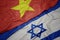 waving colorful flag of israel and national flag of vietnam