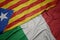 waving colorful flag of italy and national flag of catalonia