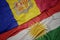 waving colorful flag of kurdistan and national flag of andorra