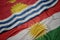 waving colorful flag of kurdistan and national flag of Kiribati