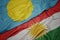 waving colorful flag of kurdistan and national flag of Palau