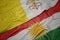 waving colorful flag of kurdistan and national flag of vatican city