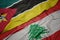 Waving colorful flag of lebanon and national flag of mozambique