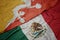 Waving colorful flag of mexico and national flag of bhutan.