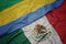 Waving colorful flag of mexico and national flag of gabon.