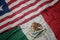 Waving colorful flag of mexico and national flag of liberia.